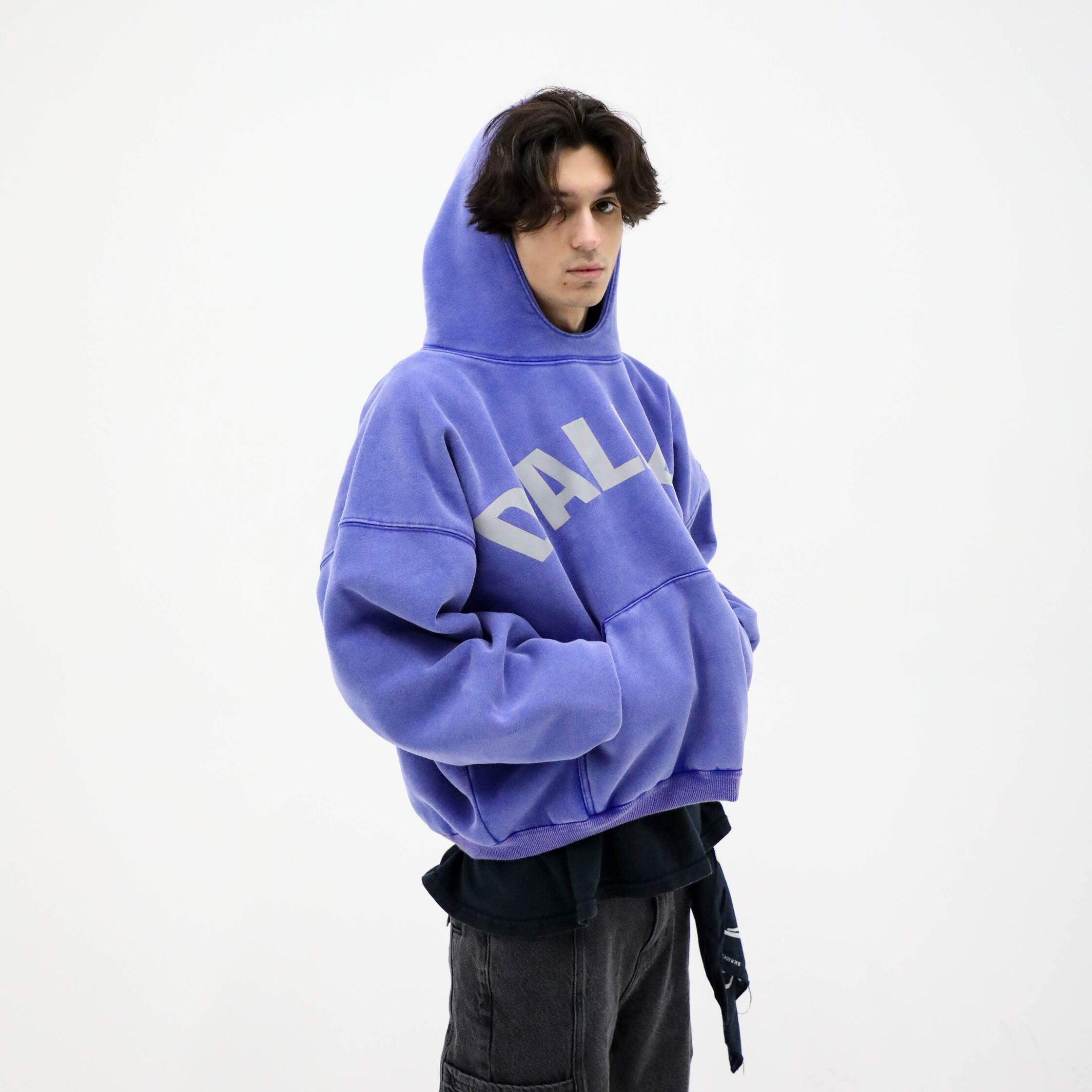 Person wearing a blue hoodie with 'DALLAS' text on a white background